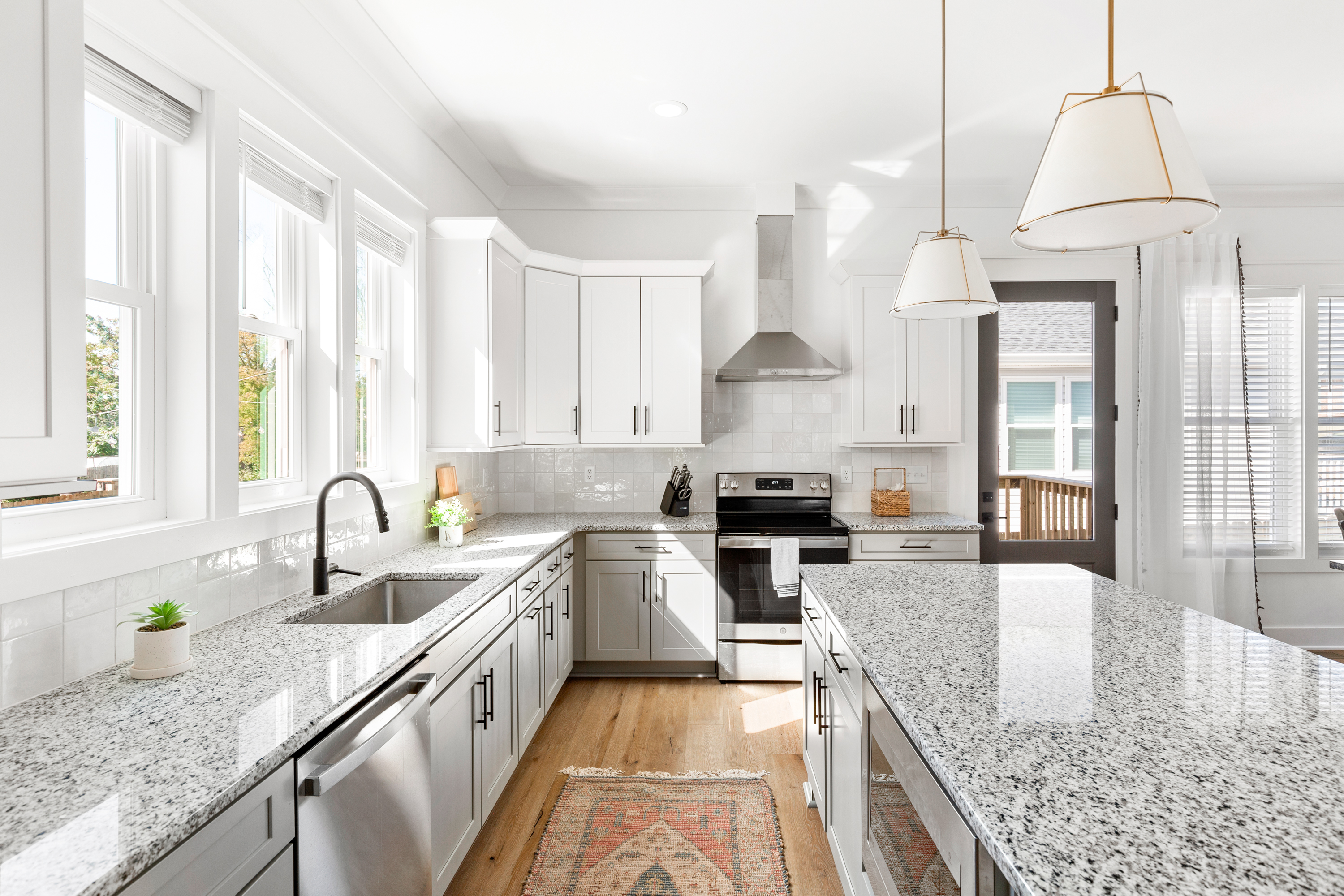 Bright kitchen with natural light, subway tile backsplash, and stylish fixtures